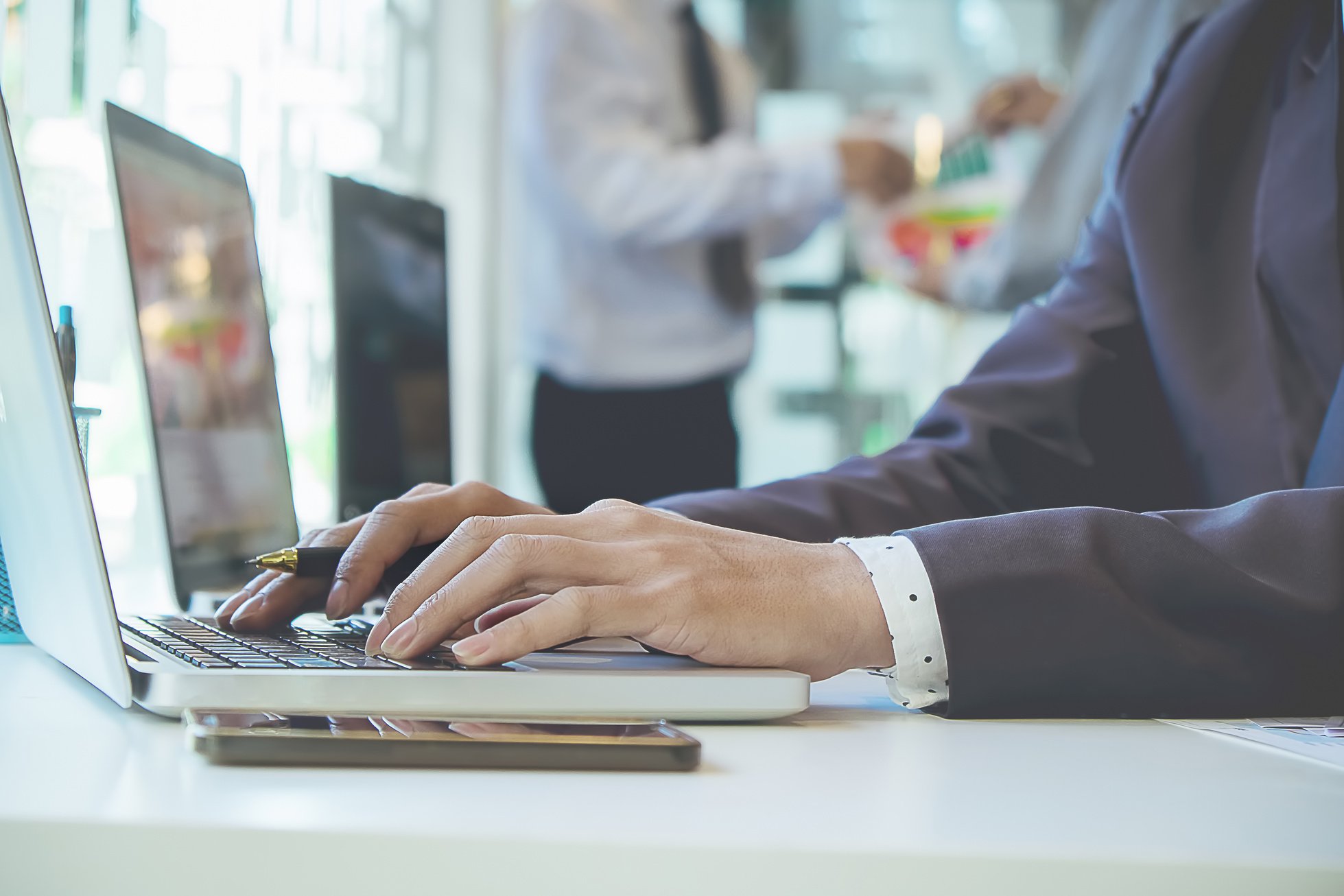 Business Man Using Laptop Computer on Office Table